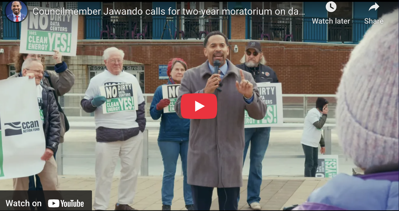 Councilmember Jawando speaks at a rally calling for a two-year moratorium on data centers, joined by community advocates holding signs