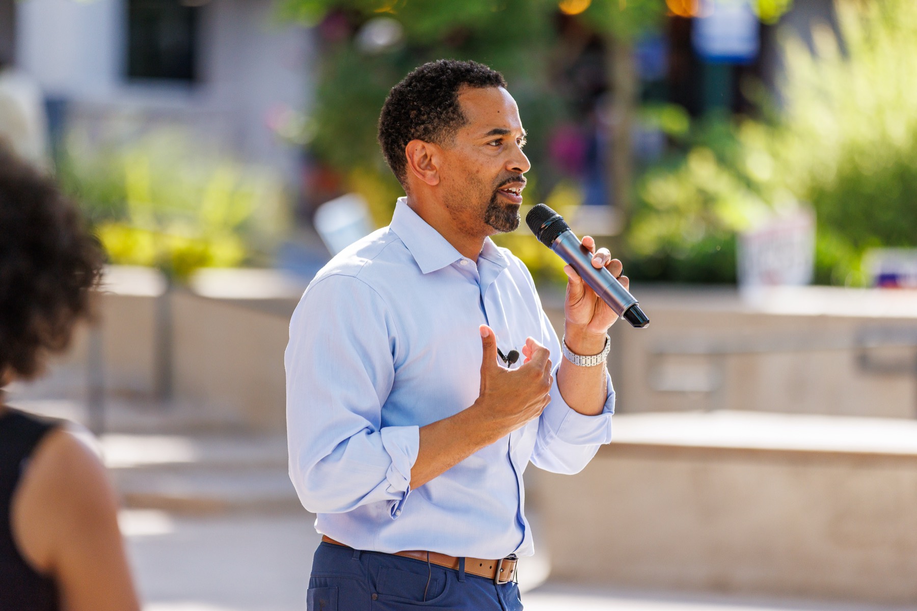Will Jawando speaking with a microphone at a campaign event